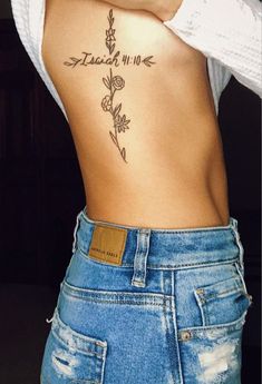 the back of a woman's stomach with tattoos on it