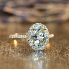 an oval shaped diamond ring on a table