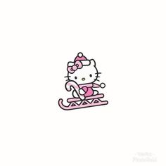 a hello kitty sitting on top of a sled with a pink bow in her hair