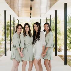 the bridesmaids are all dressed in mint green dresses and posing for a photo