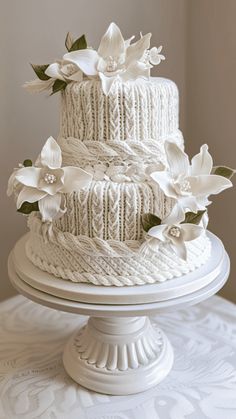 a white wedding cake with flowers on top