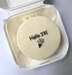 a cake in a foam container with writing on it