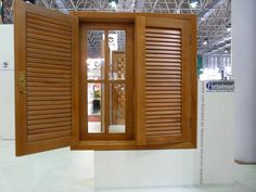 an open window with wooden shutters on display