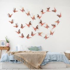 a bedroom with white walls and lots of butterflies on the wall