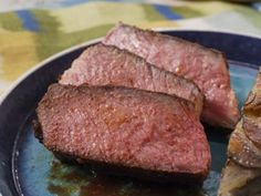 two pieces of steak on a blue plate