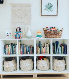 the bookshelf is filled with many different types of books and baskets on it