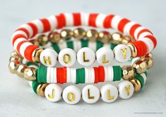 three bracelets with white, red and green beads on them that say holly in gold letters