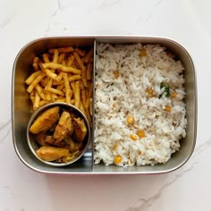 a metal container filled with rice and fries