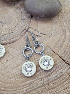 A sweet size diameter, these earrings are simple yet distinct in SureShot styling! 28 gauge shotgun casings set in smooth stainless steel bezels and suspended from stainless steel French wires by thick stainless jump rings is our signature method. Length: ~2 1/4"Earring keepers included. Primer centers vary. Brand will be Winchester. NOTE: If you are an avid huntress, you will recognize that the 28 gauge casings we use in all of our designs are the "old style" Winchester brand casings, ones that Bullet Designs, Bullet Earrings, Bezel Pendant, French Wire, Large Earrings, Old Style, Jump Rings, Fashion Earrings, Washer Necklace