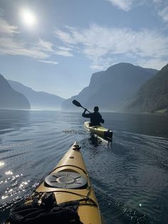 a person in a kayak paddling on the water