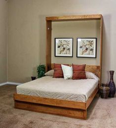 a bedroom with a bed and two framed pictures on the wall