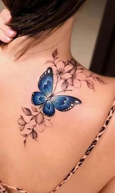 a woman with a blue butterfly tattoo on her back