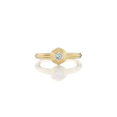 a yellow gold ring with a white diamond in the center and two thin bands around it