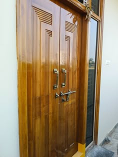 two wooden doors with metal handles on each side