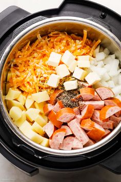 the food is being cooked in the crockpot with cheese and other ingredients inside