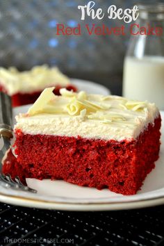 a piece of red velvet cake on a white plate next to a glass of milk