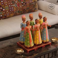 a group of figurines sitting on top of a coffee table next to a couch