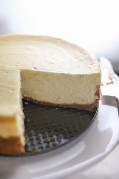 a cheesecake on a plate with one slice missing