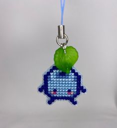 a keychain with a blue and green bead design on it's side