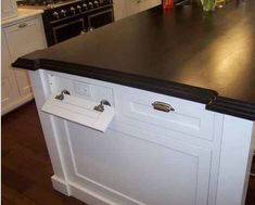 a black counter top in a white kitchen