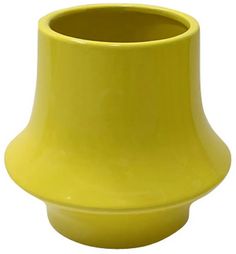 a yellow vase sitting on top of a white table