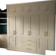 a large white cabinet with drawers and shelves