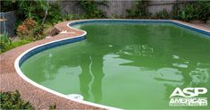 an empty swimming pool with green water