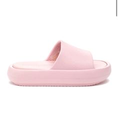 a pair of pink slippers on white background