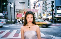 a woman standing in the middle of a busy street