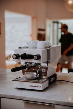 an espresso machine sitting on top of a counter