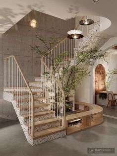 a staircase in the middle of a living room with potted plants on either side