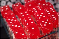 red dices with white polka dots on them sitting in a display case at a casino