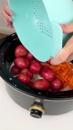 a woman is grating carrots and radishes in an air fryer