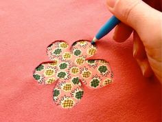 someone is stitching flowers on a t - shirt