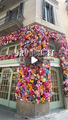 a building covered in lots of colorful flowers