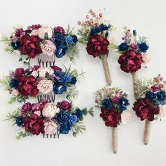 three hair combs decorated with flowers and greenery on white wall behind each other