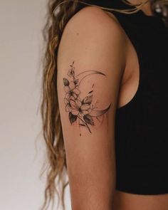 a woman's arm with a flower tattoo on the left side of her arm