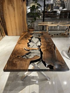 a wooden table sitting on top of a white tiled floor