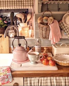 the kitchen counter is cluttered with dishes and utensils, such as tea kettles