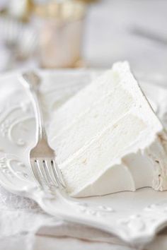 a piece of cake sitting on top of a white plate next to a knife and fork