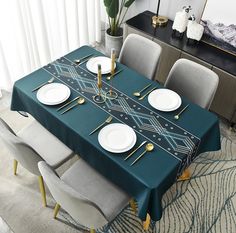 a dining room table set with plates and place settings