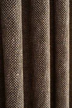 a close up view of a curtain with black and white checkered fabric