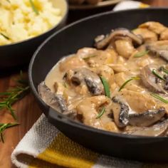 a skillet filled with mushrooms and gravy next to a bowl of mashed potatoes