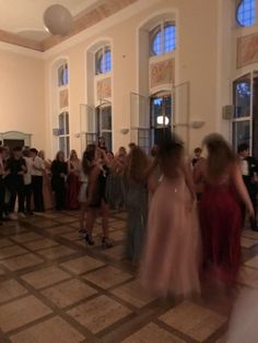 a group of people that are standing in the middle of a dance floor