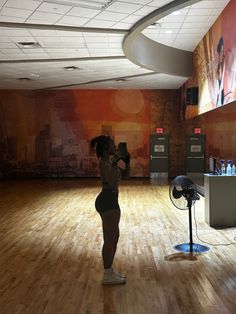 a woman taking a photo in an empty room