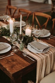 the table is set with candles and place settings