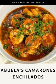 a white bowl filled with shrimp and tomato soup