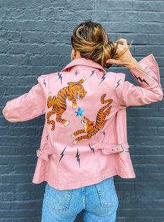 "One of a kind vintage pink leather jacket with hand-painted tigers, lightning bolts and sweet cherries on the front lapel.  A piece of wearable art symbolizing ferocity, power and good fortune.  Brand: Together Leather Size: Women's 10 Hand-painted with Angelus and signed by the artist MEASUREMENTS Shoulder: 17\" Bodice length: 24\" Arm length: 24.5\" Bust: 19\" (measured laying flat, across front)  pink motorcycle jacket  pink leather jacket  year of the tiger  wearable art  painted leather  l Upcycled Vintage Paintings, Leather Jacket Upcycle, Paint Leather Jacket, Hand Painted Leather Jacket, Hand Painted Jacket, Pink Motorcycle, Punk Jacket, Painted Leather Jacket, Custom Leather Jackets