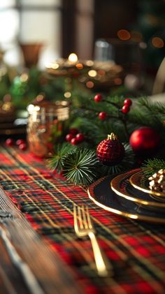 the table is set for christmas dinner with red and green plaid napkins on it