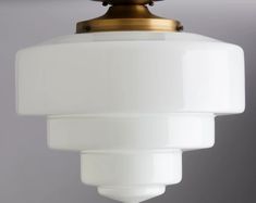 a white light hanging from a ceiling fixture